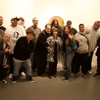 Group of 14 friends pose for a photo in art gallery