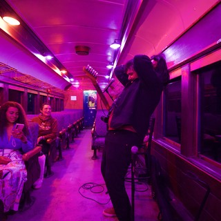 Purple-Lit Vintage Train Car Performance Space
