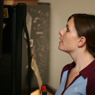 Woman Gazing Into Open Refrigerator Late Night