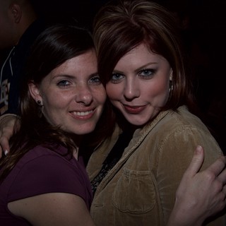 Two Friends Embrace at a Nighttime Event