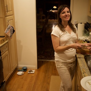 Woman Preparing Food in Warm Kitchen at Night