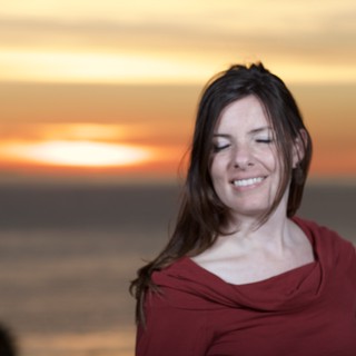 Serene Woman Smiling at Golden Sunset