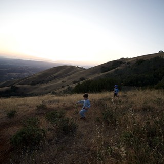 Children Playing on Golden Hills at Dusk