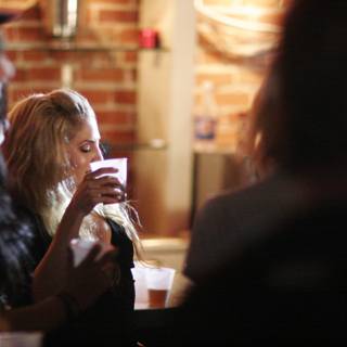 A Woman Enjoying a Beer at a Restaurant