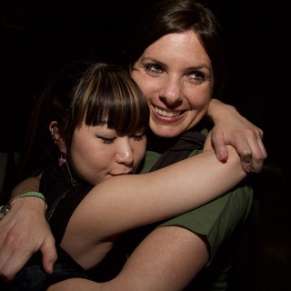 Two Friends Share a Warm Embrace at Night