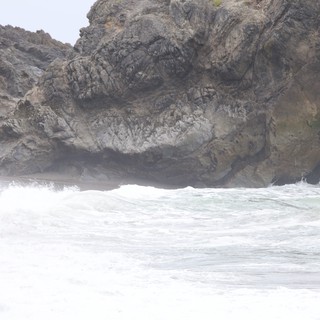 Turbulent Waves Crash Against Rugged Coastal Cliffs