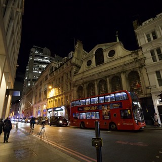 Red Double-Decker Bus on London Street at Night