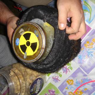 Radioactive Jar in the Hands of a Person