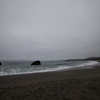 Moody Overcast Beach with Rocky Outcroppings at Dusk