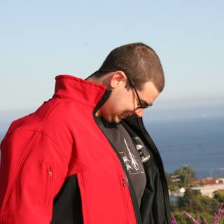 Red Jacket Against the Blue Ocean