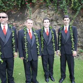 Four Men in Suits Posed by a Rock Wall