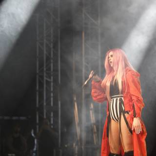 Pink-haired performer rocks the stage in red
