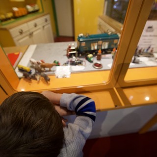 Child Exploring Museum Display Through Glass Case