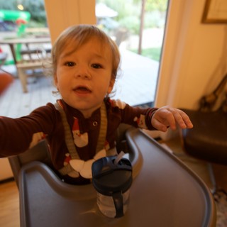 Toddler in Festive Pajamas Reaching Toward Camera