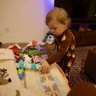 Toddler Opening Christmas Presents at Home