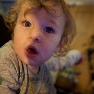 Surprised Toddler with Curly Blonde Hair Looking Up