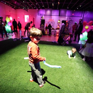 Child Dancing at Colorful Baby Rave Art Installation