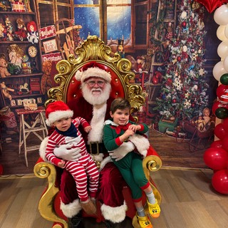 Two Children Visit Santa in His Workshop Grotto