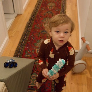 Toddler in Santa Pajamas Holding Christmas Toy