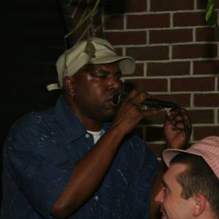 Entertainer Steve J performing with two hats and a microphone