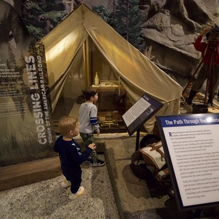 Children Exploring Historical Mountain Crossing Tent Exhibit