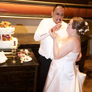 The Bride and Groom with the Wedding Cake