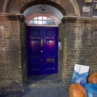 Purple Door Number 83 with Ornate Brick Archway in London
