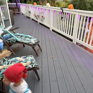 Child in Motion on Decorated Hillside Deck
