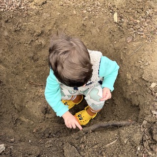 Toddler Exploring and Playing in Muddy Dirt