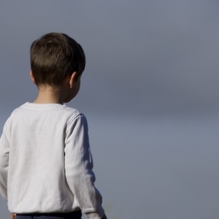 Young Boy Gazes Toward the Horizon in Contemplation