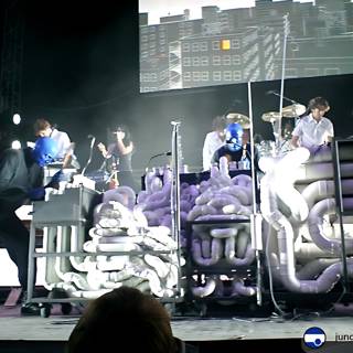 Band on Stage with Large Screen