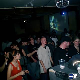 Nightclub Party with Man on Screen