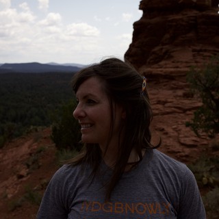 Woman Smiling Atop Red Rock Canyon Vista