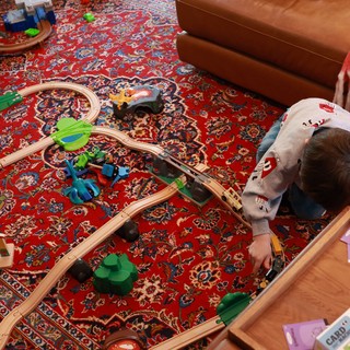 Child Playing with Wooden Train Set on Christmas Day