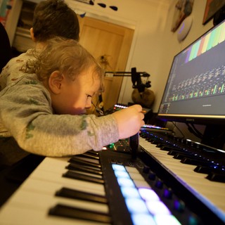 Young Child Learning Music Production with Parent