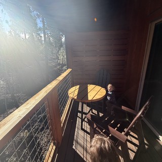 Children Exploring a Sunlit Cabin Deck in Yosemite