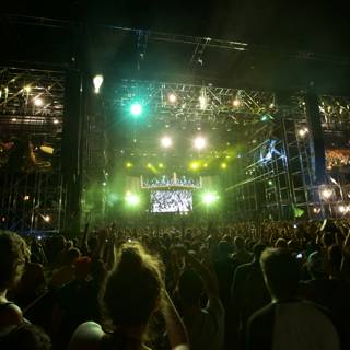 Green Spotlight on Rock Concert Crowd