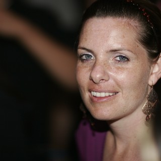 Smiling Woman with Blue Eyes at Evening Event