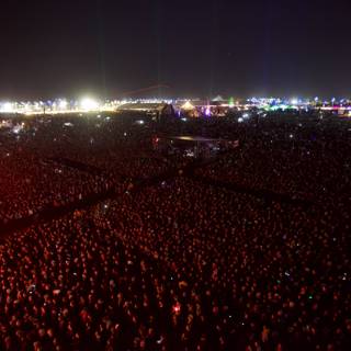 Massive Crowd Rocks Out to Concert Performance Under a Night Sky