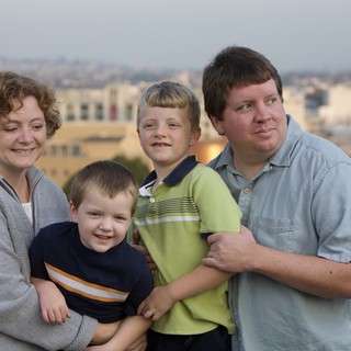Family Portrait at Dusk with City Skyline