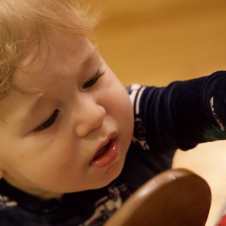 Curious Toddler with Blonde Hair at Mealtime