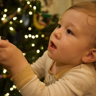 Toddler's Wonder While Decorating the Christmas Tree