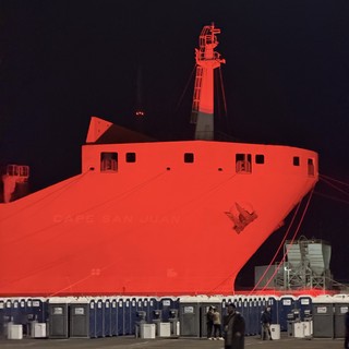 Massive Red-Lit Ship Hull at Night Event