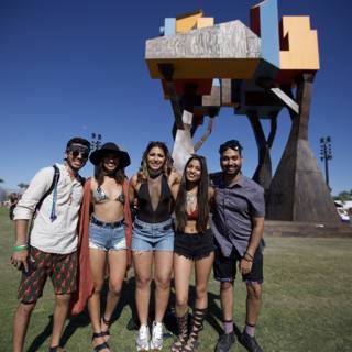 Four Friends Strike a Pose in Front of a Sculpture