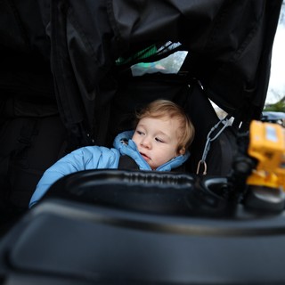 Curious Toddler Explores Stroller Storage Compartment