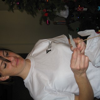 Woman Opening Christmas Gift on Christmas Eve