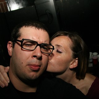 Unexpected Kiss at a Dimly Lit Bar Party