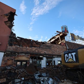 Tornado Destruction Site with CAT Excavator and Debris