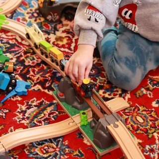 Child Playing with Wooden Train Set on Christmas Day
