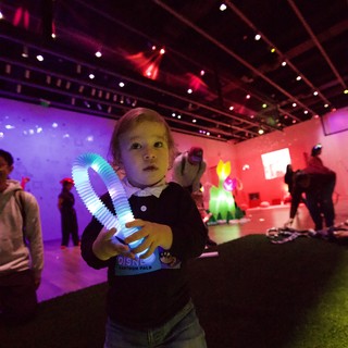 Child with Light Toy at Baby Rave Event